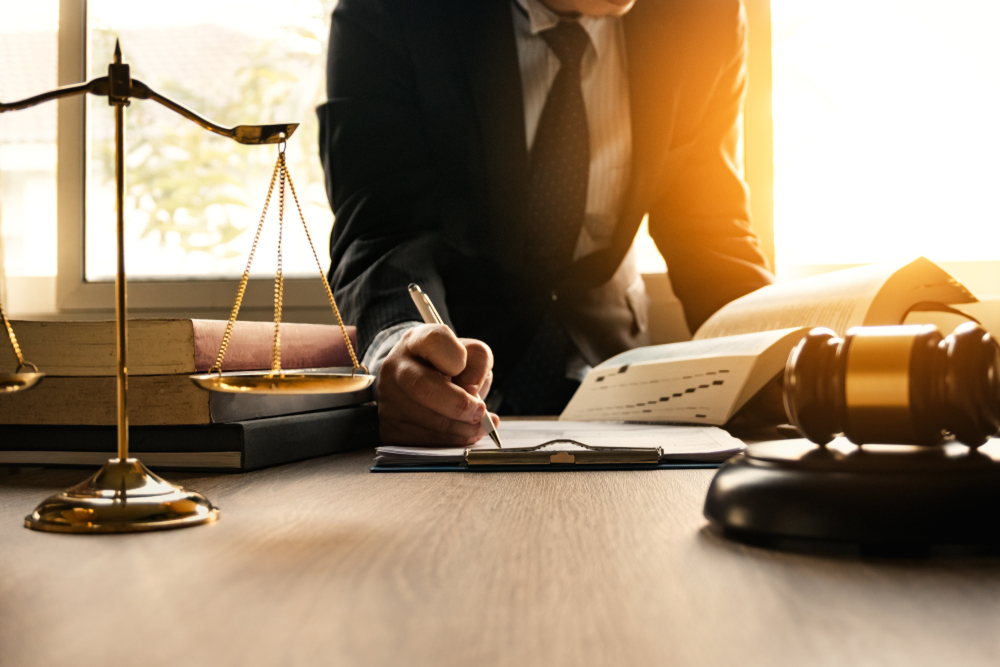 Male lawyer working with contract papers and wooden gavel on tabel in courtroom